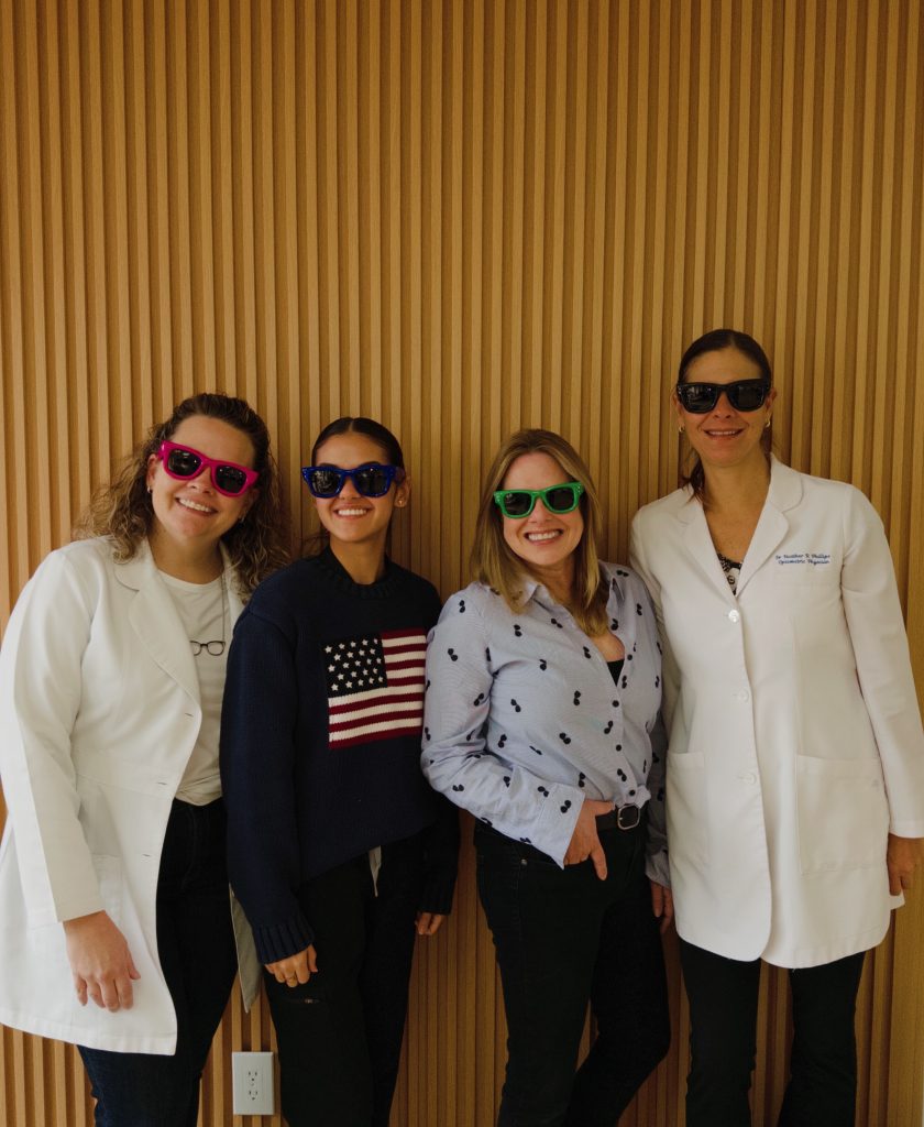 Style Site Optical team members trying on sunglasses in the Aventura office